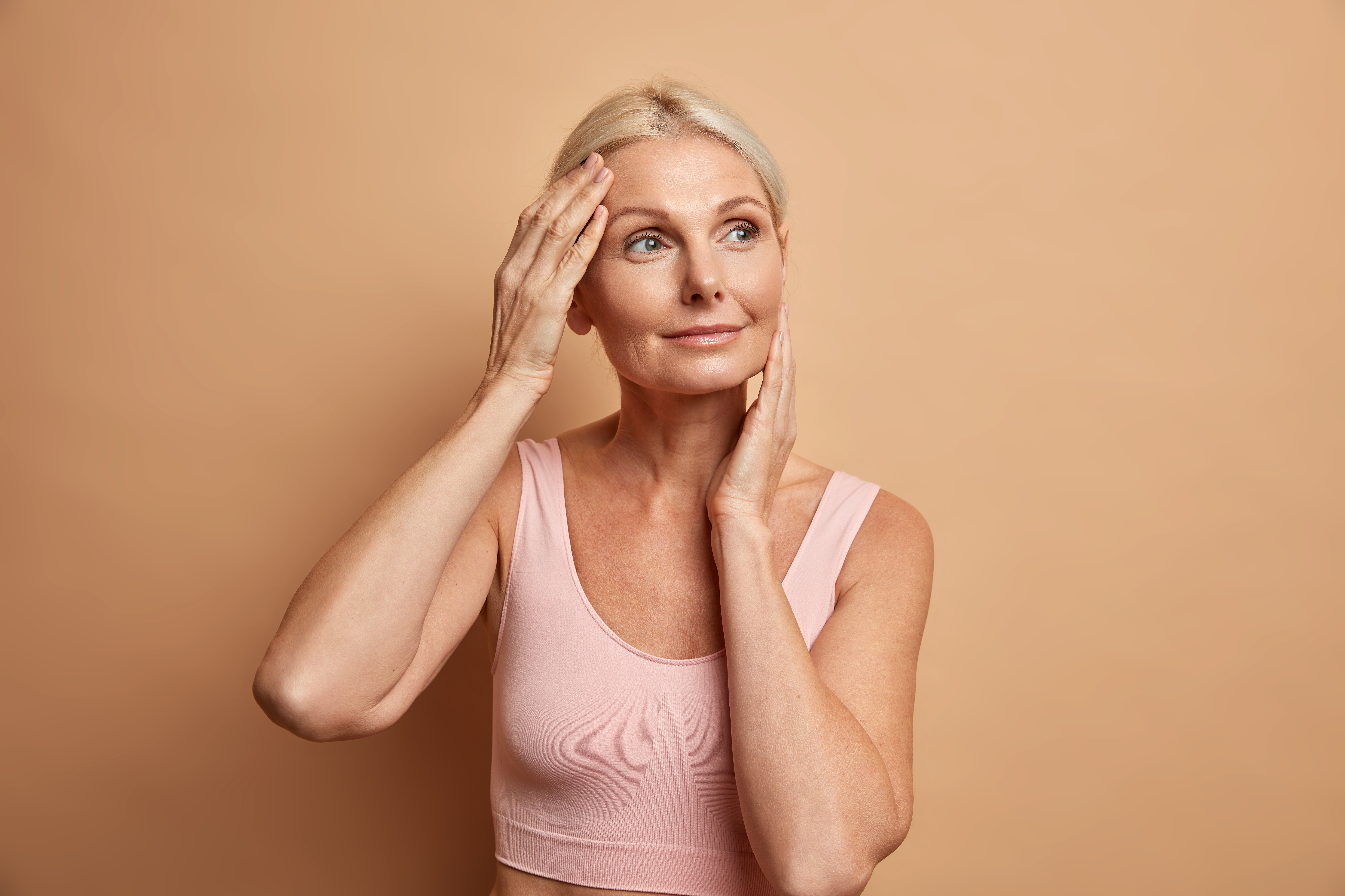 portrait-of-mature-elderly-european-woman-touches-face-gently-has-perfect-skin-and-looks-thoughtfully-away-enjoys-her-soft-complexion-cares-about-appearance-satisfied-after-anti-aging-procedure.jpg